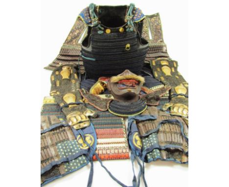 An Edo style Japanese part suit of Gusoku armour, to include open face mask helmet with stylised beard, mesh work embroidery 