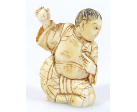 A 19thC Japanese Meiji period netsuke, formed as a figure in flowing robes, with two pierced holes verso, he in seated positi
