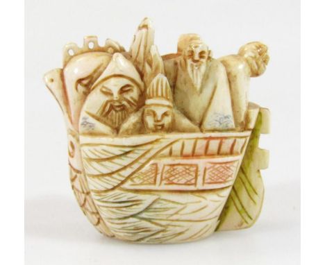 A 19thC Japanese Meiji period netsuke, formed as figures in a boat, partially coloured with two character mark and two drill 