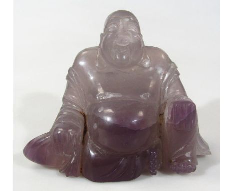 A 20thC Chinese amethyst coloured glass sculpture of Buddha, in seated pose, in flowing open robes, unmarked, 18cm high.