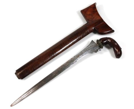 A polished hardwood Malayan kris, with plain silvered blade and shaped handle and elaborate axe head scabbard, 46cm wide.