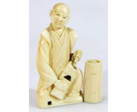 A 19thC Japanese ivory figure of a gentleman, in flowing robes, sat aside barrel, marked beneath, 10cm high.