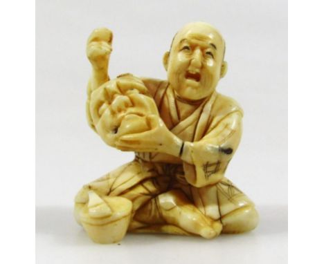 A 19thC Japanese ivory netsuke formed as seated gentleman, in flowing robes holding mask, with black signature mark beneath, 