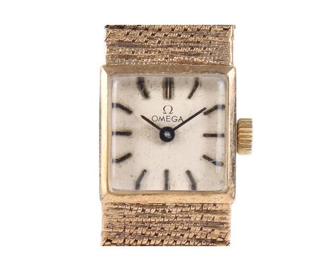 A lady's late twentieth century hallmarked 9ct gold Omega dress watch. Square dial with integral mesh bracelet. Mechanical mo