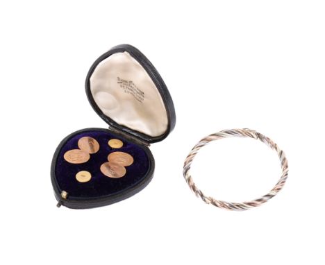 A small group of gold jewellery. Comprising a 9ct hallmarked gold twist bangle, a pair of 9ct hallmarked cufflinks, these all