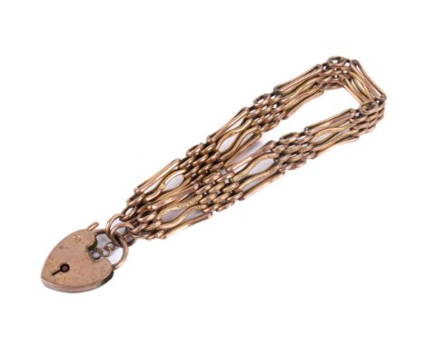 A yellow metal gate link bracelet and heart padlock. Both stamped '9ct', the bracelet with engraved details to the bands, 14.