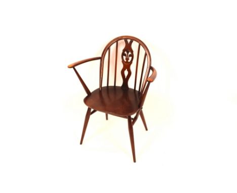 A dark Ercol stick back elbow chair 