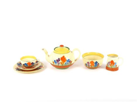 A Clarice Cliff "Crocus" pattern part tea set, comprising three tea cups and saucers, sugar bowl, cream jug, tea plates and s