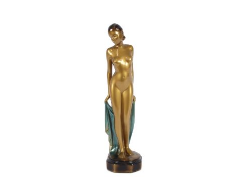 A composite figure of a naked Art Deco girl, holding a cloak, 34cm high