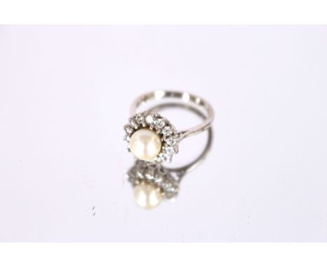An 18ct white gold, pearl and diamond set cluster ring, approx. 5.4gm total weight