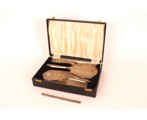 A cased silver Art Deco design three piece dressing table set, with engine turned decoration