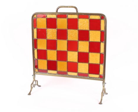 An Arts &amp; Crafts design brass and stained glass firescreen, 66cm