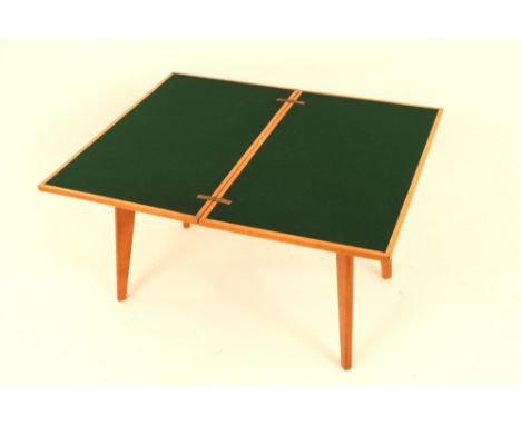 A 1970's light oak folding card table, swivel top raised on square section supports, 67cm