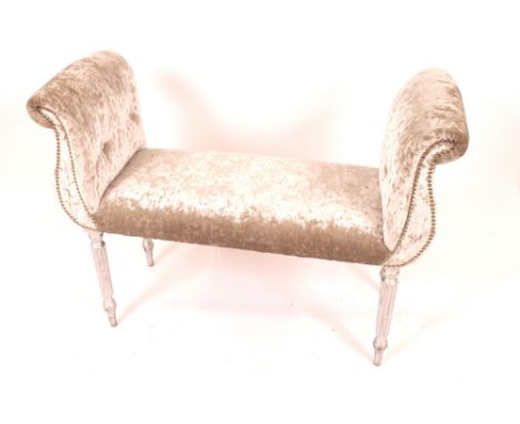 A duet stool with silver crushed velvet upholstery, raised on reeded supports, 104cm long