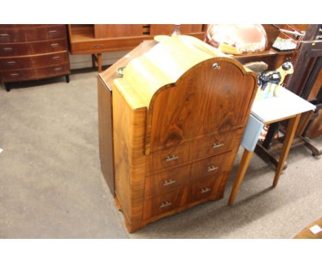 An Art Deco burr walnut secretaire, the fall front opening to reveal a fitted interior above three drawers with chrome handle
