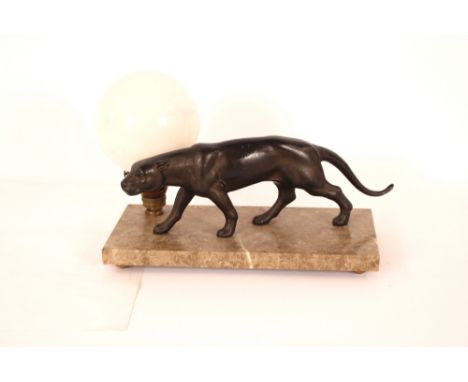 An Art Deco lamp, in the form of a prowling bronzed tiger, on marble base, the light with globular white opaque shade