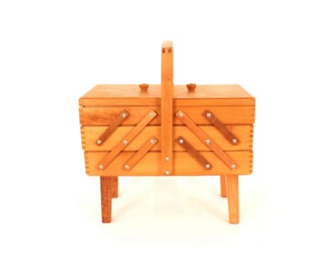 A light wood 1960's / 70's cantilever sewing box 