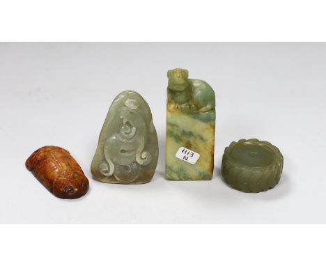 A Chinese green jade 'cash' wheel and a russet jade cicada, a jade pebble carving and a hardstone seal