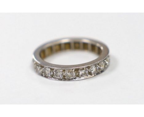 A white metal and diamond set full eternity ring, size J/K, gross weight 4.3 grams.