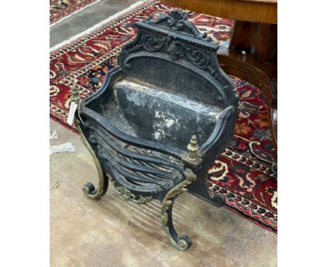 A cast iron and brass serpentine fire grate, width 46cm, depth 29cm, height 66cm