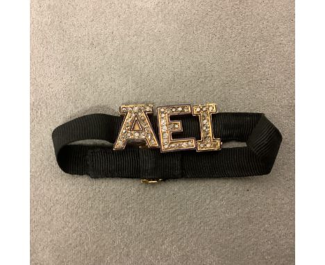 Unmarked yellow metal enamel and old cut diamond trio of letters AEI, very slight losses to some enamel 