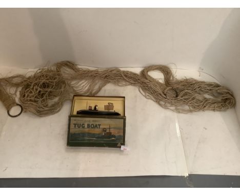 Vintage Tugboat toy in its original box, and a sailors old string hammock 