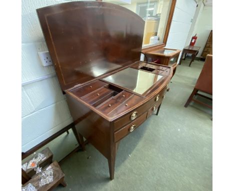 A Sheraton revival inlaid mahogany bow front dressing table, with a fitted compartmented interior, below a rising lid, 122 Wi