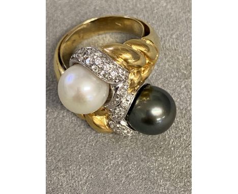 An  impressive 18ct gold black and white pearl cross over ring, with central band of platinum mounted single cut diamonds, wi