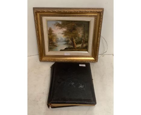A large leather album of old vintage photos and a painting 