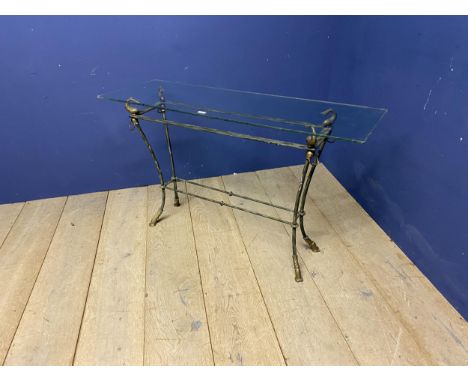 A good decorative, glass topped, narrow console table, with decorative iron work and brass base, with shaped fish carved supp