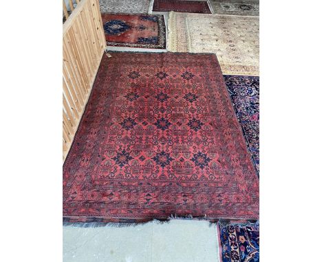 Light burgundy ground Persian Rug,  100% wool , hand knotted with 12 blue lozenges set in a stylized background and wide mult
