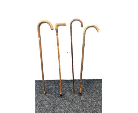 Selection of 4 vintage walking sticks, with silver rims 