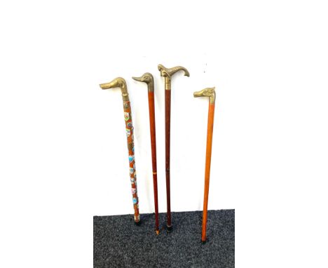 Selection of vintage wooden walking sticks with brass handles includes mermaid, duck, dog and horse 