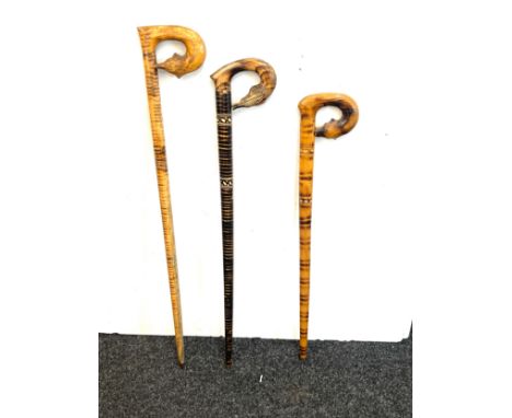 Three vintage carved handled walking sticks 