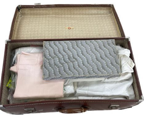 Selection of vintage linen in a vintage travel case 
