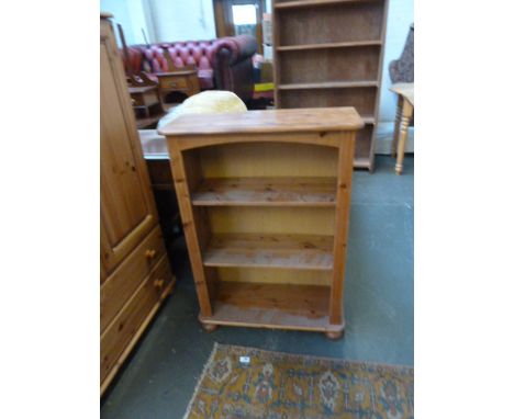 A 20th century pine two shelf bookshelf, reeded sides on bun feet, 67cmW