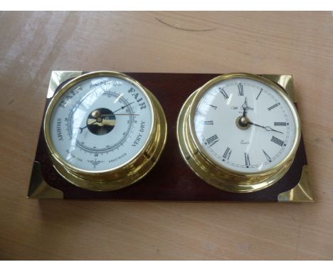 A William Widdop clock barometer, on mahogany backing with brass mounts, 26cm
