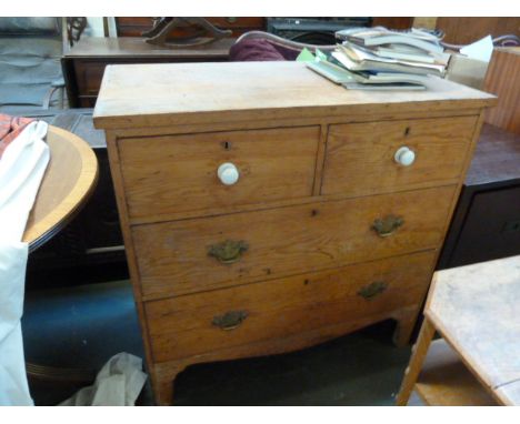 An early 19th century pine chest of drawers, two short over two long, with carved apron and bracket feet, 94cmW