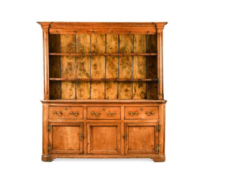 An elm dresser, 18th century, the moulded cornice above a boarded plate rack with display hooks, the bottom section with thre