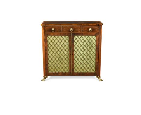 A Regency rosewood side cabinet, the crossbanded top above three short drawers with lion ring handles over a pair of brass gr