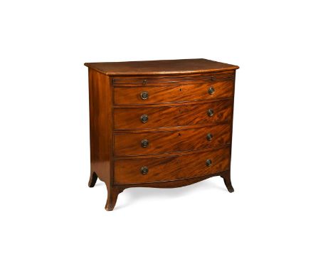 A late George III mahogany bow front chest, the brushing slide over four long graduating drawers with brass ring handles over