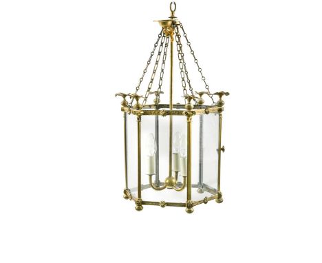 A Neo-classical style brass and glass hall lantern, 20th century, of hexagonal form with a three-light fitting and each colum
