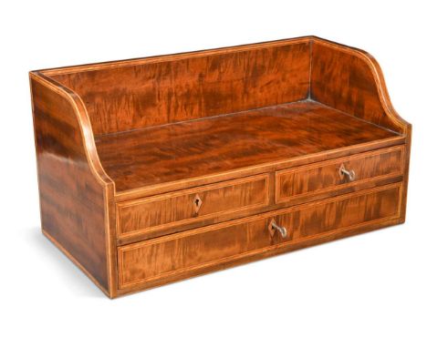 A mahogany book trough, 19th century, the three-quarter shaped gallery over a three drawer base25 x 49 x 25cmA dry crack to t