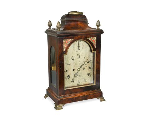 A George III mahogany bracket clock, the inverted bell top case with brass handle and four pineapple finials, the arched silv