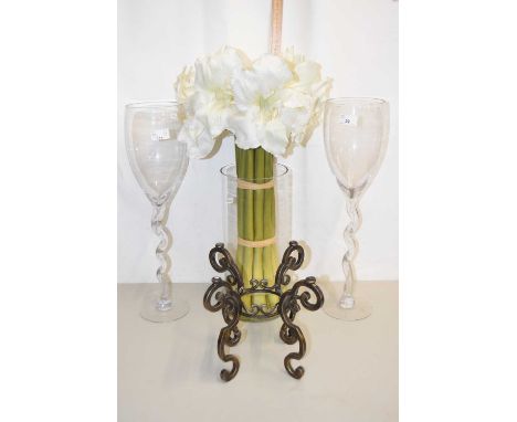 Large glass vase of simulated amaryllis flowers, pair of wine glass formed vases and a further metal stand