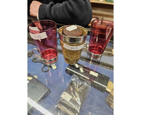 Mixed Lot: Two small cranberry beakers with silver mounts together with a horn beaker with silver collar, a small brass cigar