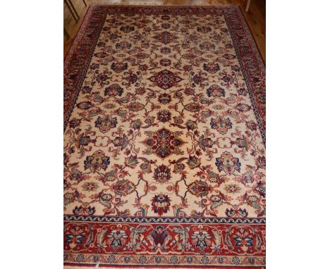 Tabriz style ivory ground carpet, the floral design field within a conforming border, 320 x 250 cm