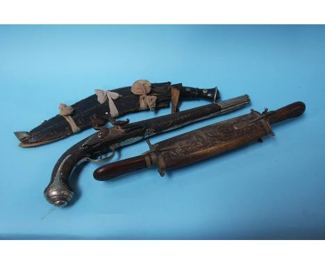 A flintlock pistol with later silver metal decoration, together with a Khukuri and a knife and fork set