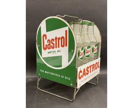 A good Castrol nine division garage forecourt oil bottle rack with enamel signs all round and nine correct Castrol quart bott