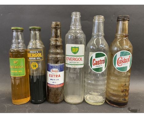 Three quart oil bottles and three pint versions, Castrol, BP and Esso. 